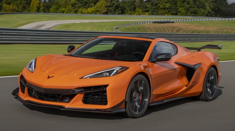 What prompted Chevy to adopt a flat plane crank in the Corvette?