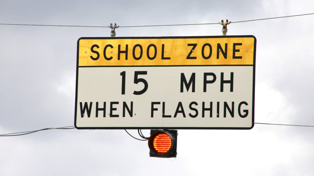 What’s the Purpose of Flashing Yellow Lights on Certain Speed Limit Signs?